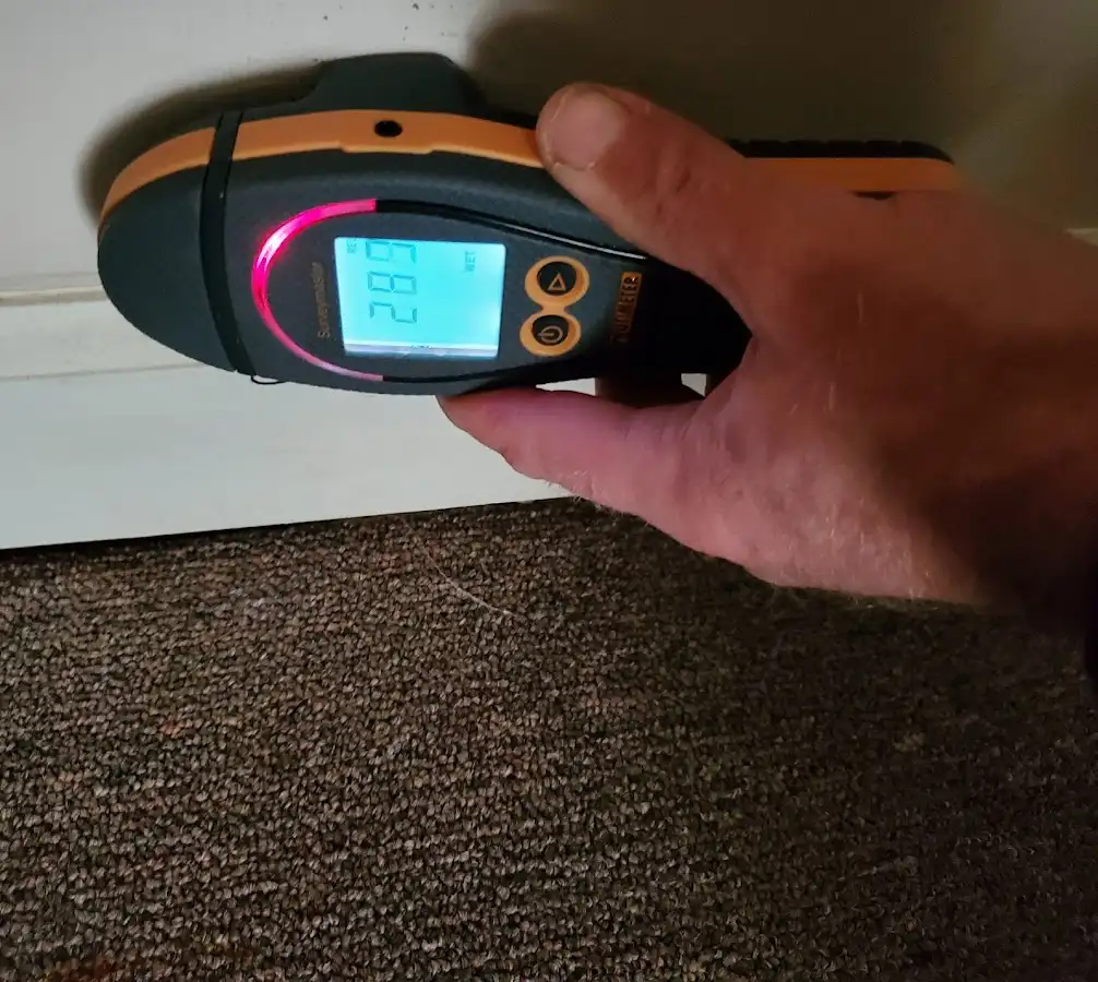 Moisture detection at baseboard during Storm Damage Restoration in Rancho San Diego